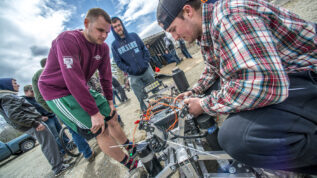 Mechanical engineering students testing their offroad vehicles that they built.