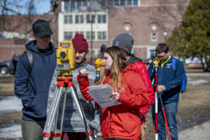 Survey Engineering Technology students practicing on the campus mall.