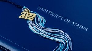 A photo of a UMaine diploma cover and tassel